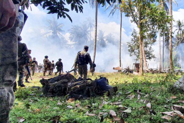 Personal belongings from victims are retrieved at the site where a Lockheed C-130 Hercules plane crashed in Patikul town, Sulu province, southern Philippines, on July 4, 2021. (Joint Task Force-Sulu via AP)