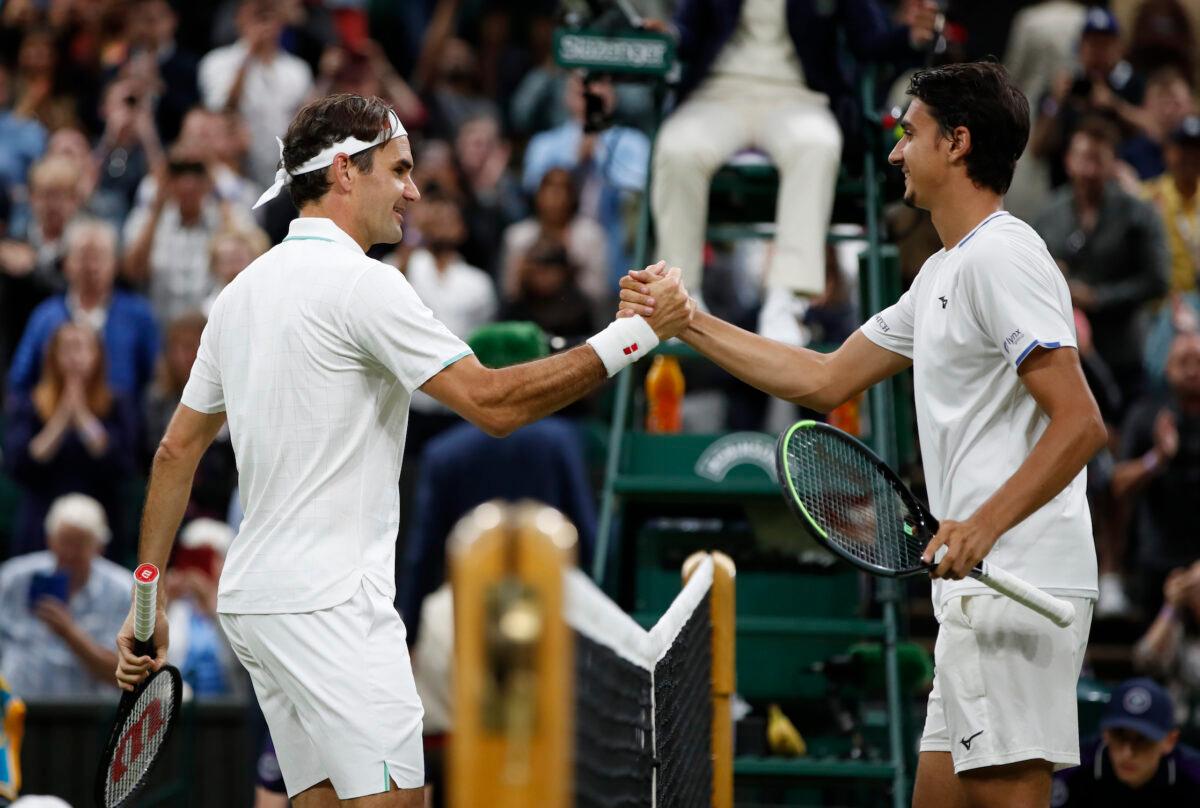 Switzerland's Roger Federer shakes hands with Italy's Lorenzo Sonego after winning their fourth round match in All England Lawn Tennis and Croquet Club, Wimbledon, London, Britain, on July 5, 2021. (Paul Childs/Reuters)
