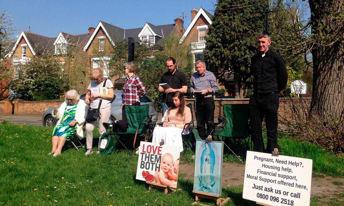 People attend an anti-abortion pro-life vigil on the street outside the Marie Stopes clinic, that offers contraception and abortion services, in Ealing, west London, on April 21, 2018. (Alice Ritchie/AFP via Getty Images)