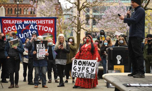Demonstrators hold placards as they protest against the Police, Crime, Sentencing, and Courts Bill 2021 in central Manchester on May 1, 2021. (Oli Scarff/AFP via Getty Images)