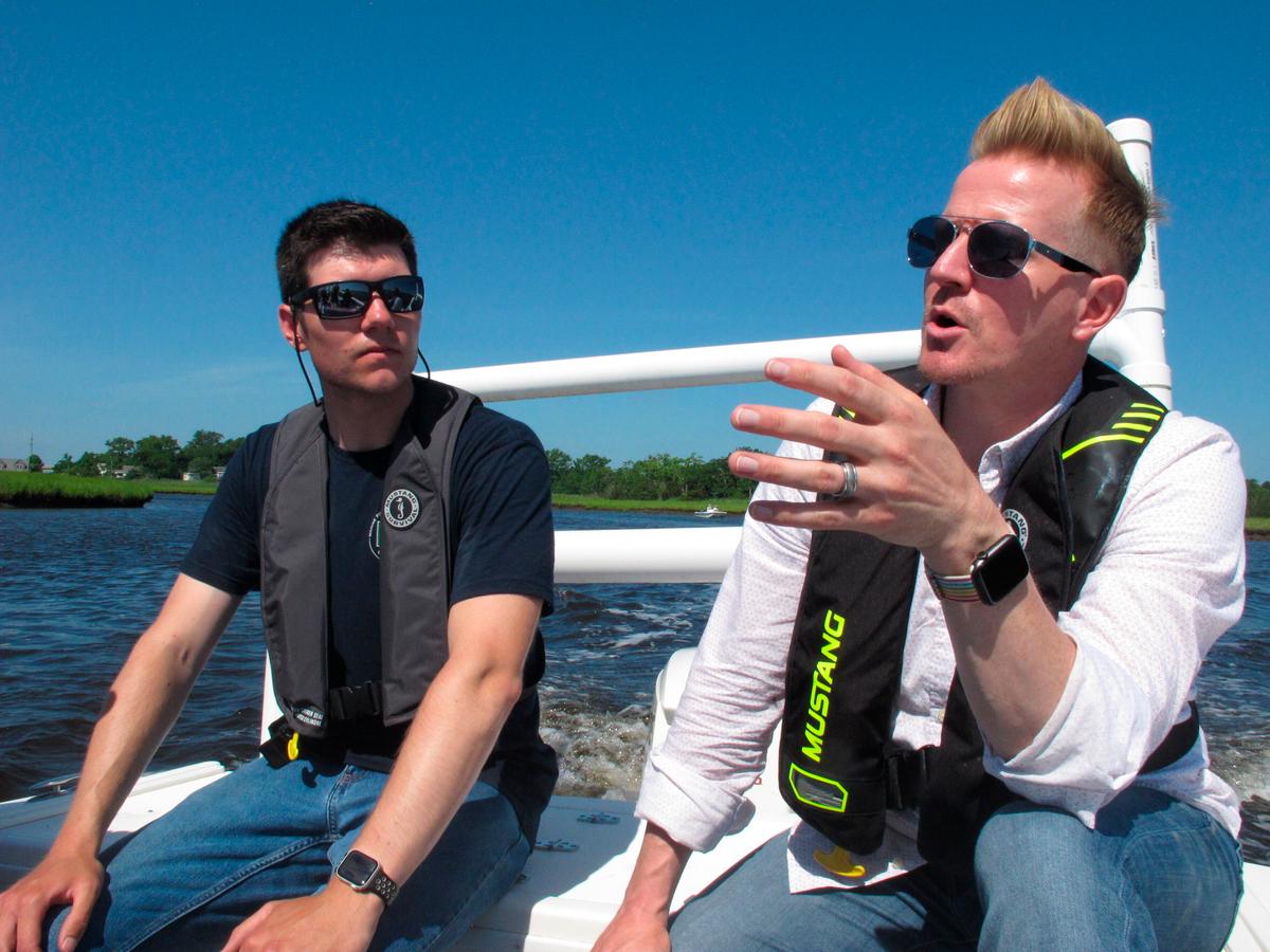 Scott Stueber (L), a biologist with the New Jersey Department of Environmental Protection, and Shawn LaTourette, the department's commissioner, discuss the state's oyster recycling and replanting program while aboard a boat in Port Republic, N.J. (AP Photo/Wayne Parry)