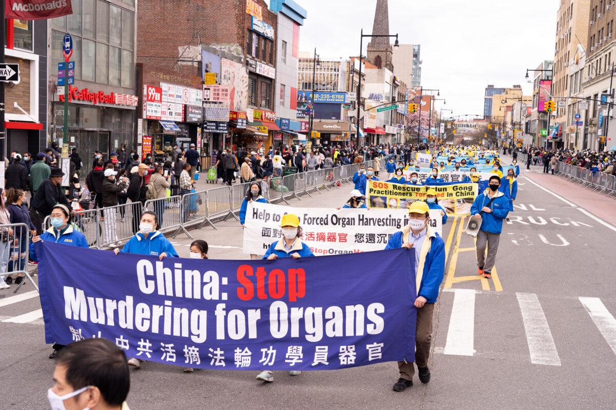 Falun Gong practitioners take part in a parade in Flushing, New York, on April 18, 2021, to commemorate the 22nd anniversary of the April 25th peaceful appeal of 10,000 Falun Gong practitioners in Beijing. (Larry Dye/The Epoch Times)