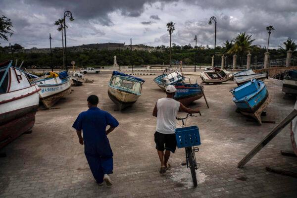 Fishermen inspect their boats after they have been taken out of the bay to avoid damage from the passage of Tropical Storm Elsa, in Havana, Cuba, on July 5, 2021. (AP Photo/Ramon Espinosa)