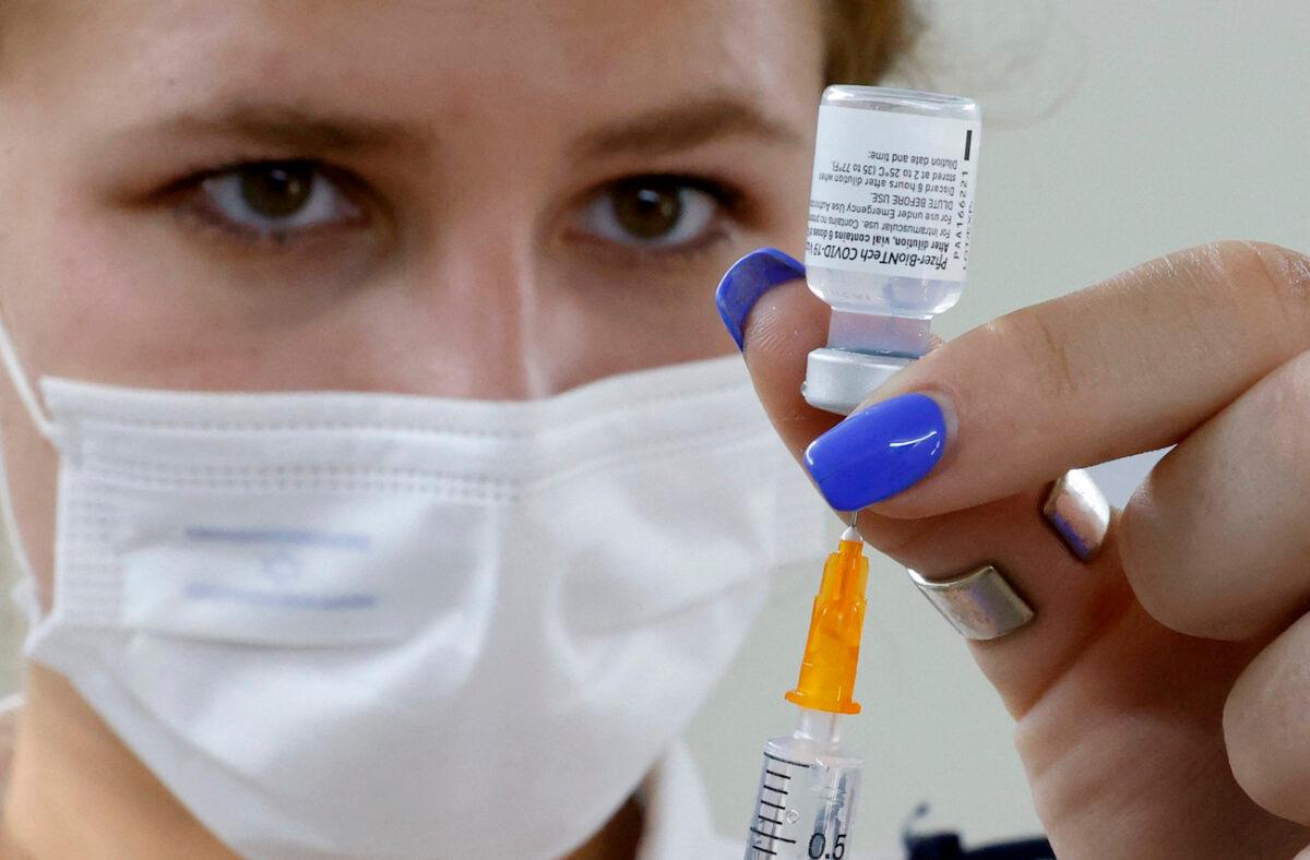 An Israeli medical worker prepares a dose of the Pfizer/BioNTech COVID-19 vaccine from the Magen David Adom in Tel Aviv, on July 5, 2021. (Jack Guez/AFP via Getty Images)