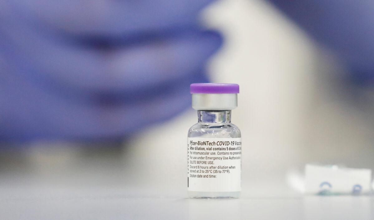 A vial of the Pfizer vaccine against the coronavirus disease is seen as medical staff are vaccinated at Sheba Medical Center in Ramat Gan, Israel, on Dec. 19, 2020. (Amir Cohen/Reuters)