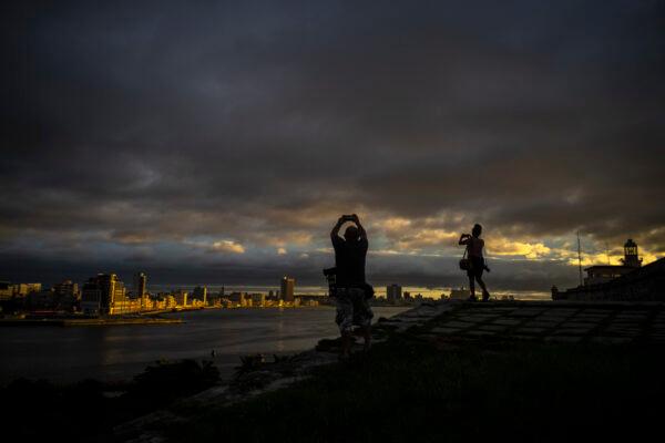Photographers take pictures of the sky full of clouds after the passage of Tropical Storm Elsa, in Havana, Cuba, on July 5, 2021. (Ramon Espinosa/AP Photo)