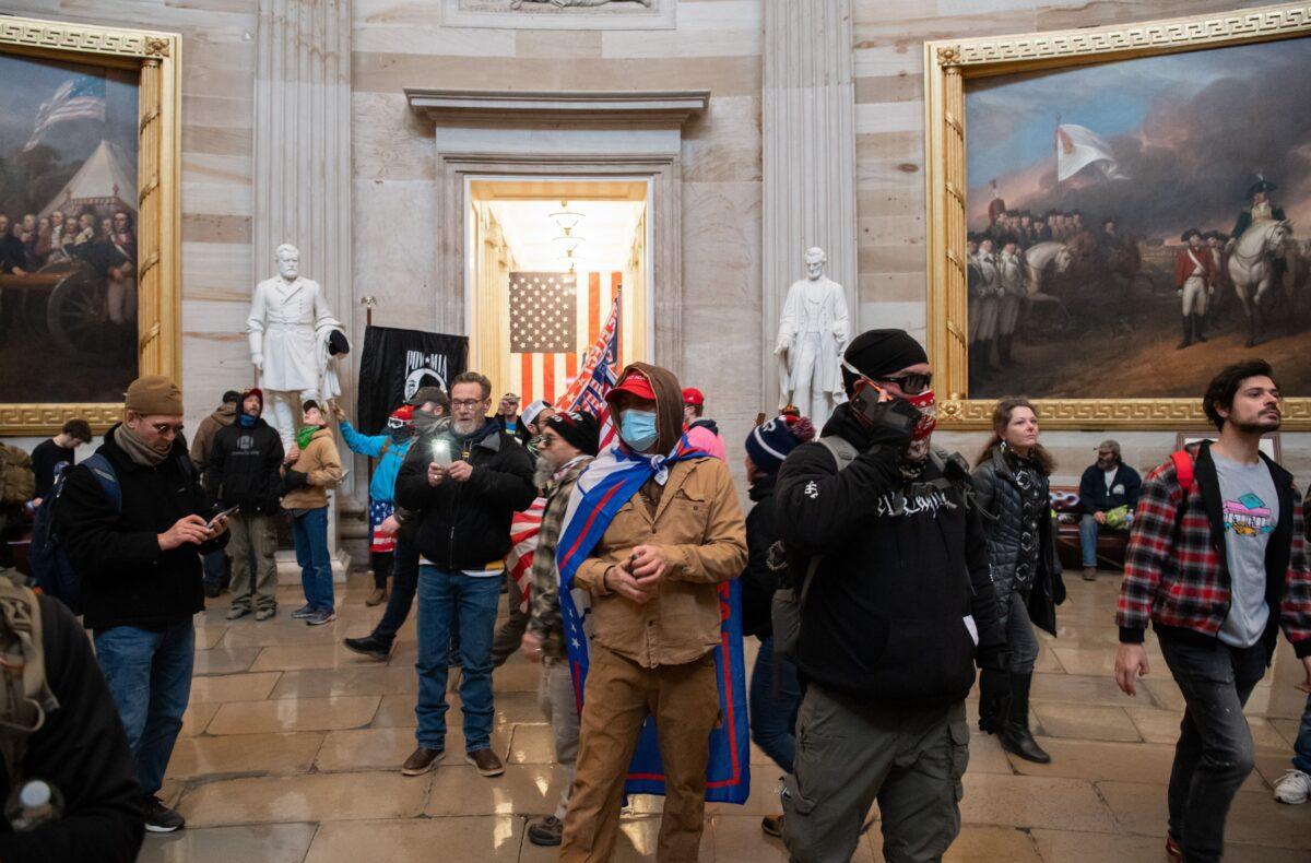 Protesters walk around in the Rotunda after breaching the U.S. Capitol in Washington on Jan. 6, 2021. (Saul Loeb/AFP via Getty Images)
