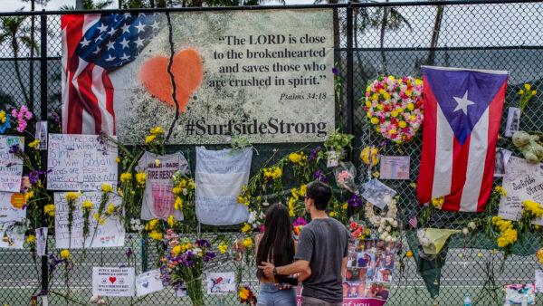Momentos, personal items and flowers are seen displayed at the Surfside Wall of Hope & Memorial in Surfside, Fla. on July 7, 2021. (Al Diaz/Miami Herald via AP)