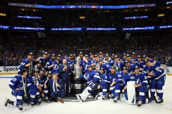 The Tampa Bay Lightning pose with the Stanley Cup after defeating the Montreal Canadiens 1-0 in Game 5 to win the NHL hockey Stanley Cup Finals in Tampa, Fla., on July 7, 2021. (Bruce Bennett/Pool Photo via AP)