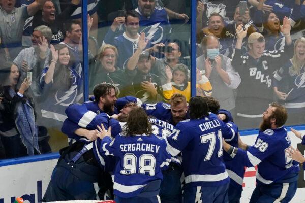 Tampa Bay Lightning teammates surround goaltender Andrei Vasilevskiy after the Lighting defeated the Montreal Canadiens 1–0 to win the Stanley Cup in Game 5 of the NHL hockey finals in Tampa, Fla., on July 7, 2021. (Gerry Broome/AP Photo)