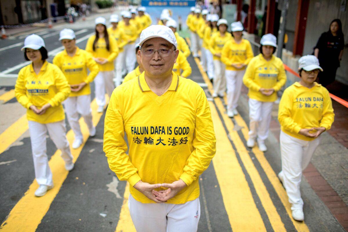Falun Gong practitioners take part in a march in Hong Kong on April 27, 2019. (DALE DE LA REY/AFP via Getty Images)
