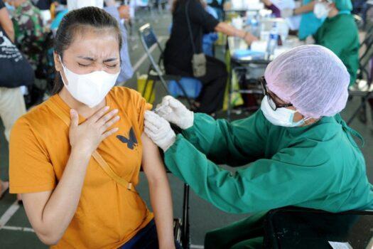 A woman receives the AstraZeneca Covid-19 coronavirus vaccine at a makeshift mass vaccination clinic in Denpasar on Indonesia's resort island of Bali on July 6, 2021. (Sonny Tumbelaka/AFP via Getty Images)