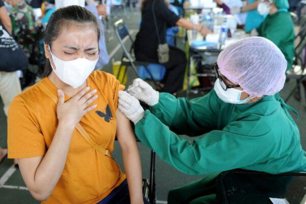 A woman receives the AstraZeneca COVID-19 coronavirus vaccine at a makeshift mass vaccination clinic in Denpasar on Indonesia's resort island of Bali on July 6, 2021. (Sonny Tumbelaka/AFP via Getty Images)