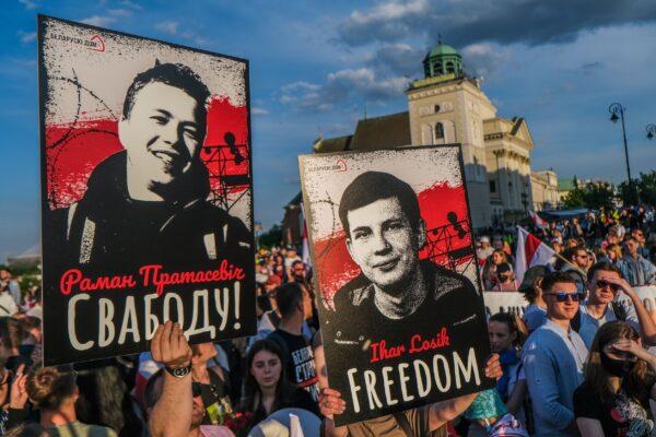 Belarusians hold banners and shout slogans as they wait for Belarus's exiled opposition leader Sviatlana Tsikhanouskaya in Warsaw, Poland, on June 3, 2021. (Omar Marques/Getty Images)