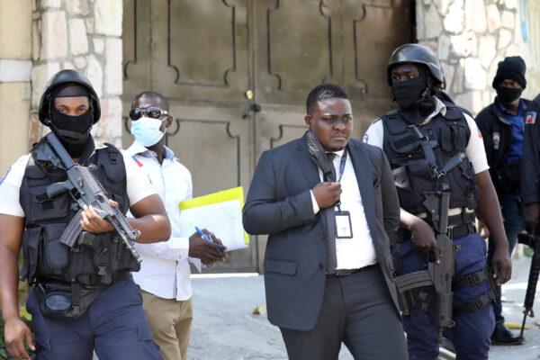 Direction Centrale de la Police Judiciaire (DCPJ) police patrol the area with forensics, as Judge Carl Henry Celestin (C) looks on outside of the presidential residence in Port-au-Prince, Haiti, on July 7, 2021. (Valerie Baeriswyl/AFP via Getty Images)