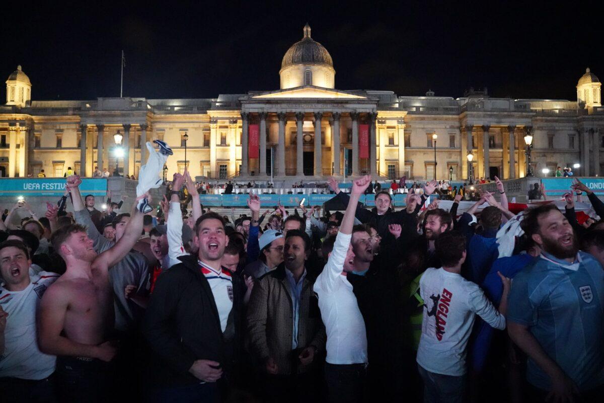 Fans in Trafalgar Square celebrate England qualifying for the Euro 2020 final, in London, on July 7, 2021. (Kirsty O’Connor/PA)