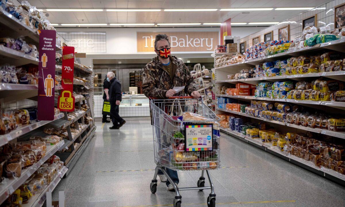 A man wearing a Union Jack flag design mask shops in a Sainsburys supermarket in Tunbridge Wells, United Kingdom, on Jan. 12, 2021. (Chris J Ratcliffe/Getty Images)