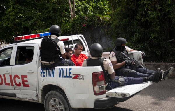 The police take two detainees to the police station of Petion Ville in Port-au-Prince, Haiti, on July 8, 2021. (Joseph Odelyn/AP Photo)
