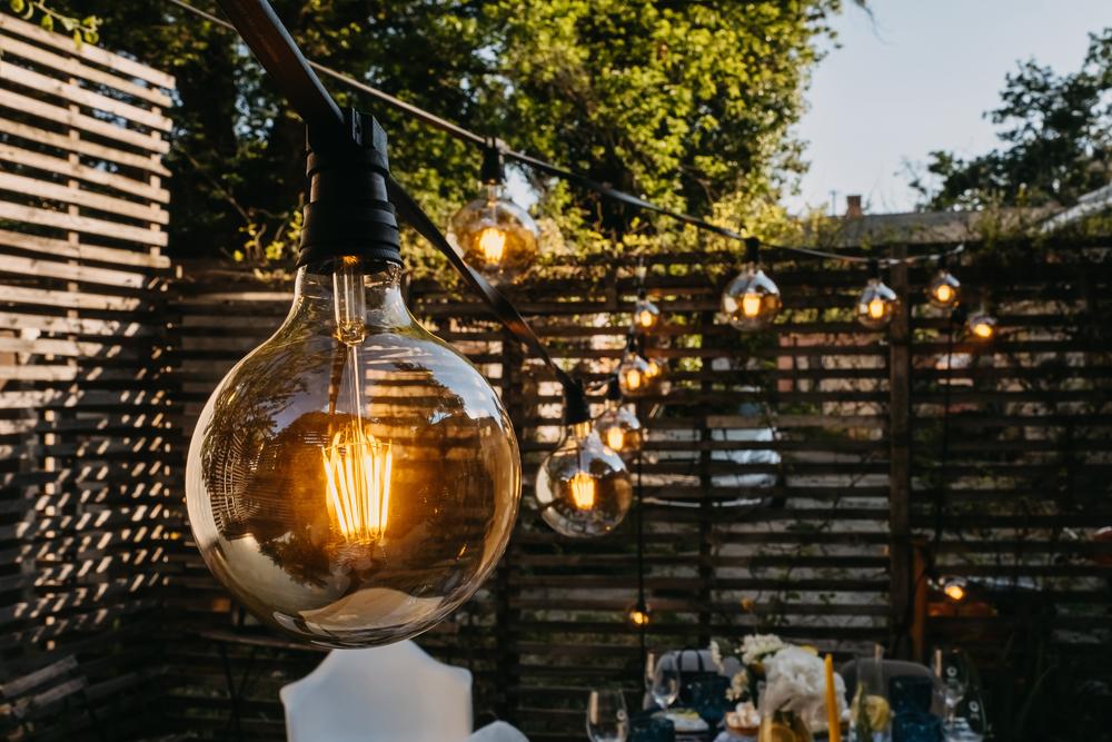 A string of outdoor lights will illuminate and visually open up your outdoor gatherings, and brighten up those dark corners. (Natalia Bostan/Shutterstock)