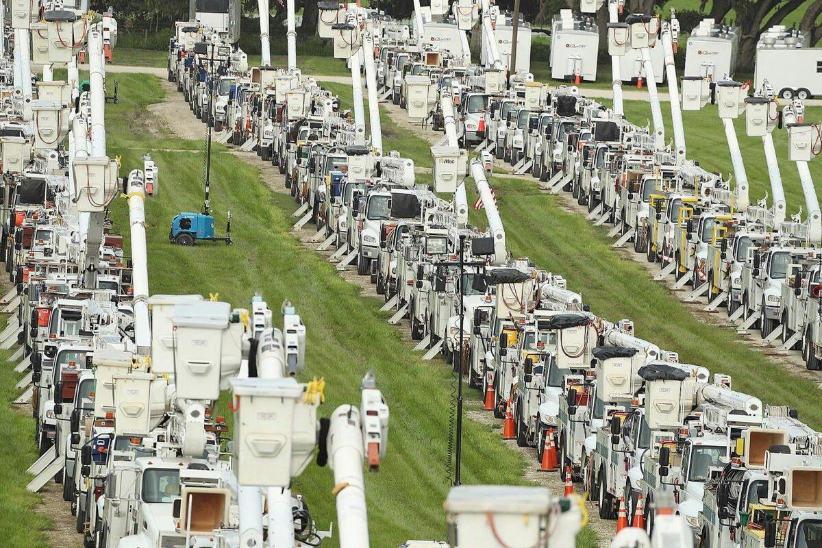 About 250 electrical utility trucks are lined up at Duke Energy's staging location in The Villages of Sumter County, on July 6, 2021. (Stephen M. Dowell/Orlando Sentinel via AP)