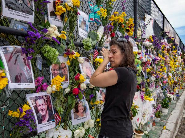 Gini Gonte visits the Surfside Wall of Hope & Memorial on July 7, 2021, as she honors her friends Nancy Kress Levin and Jay Kleiman, who lost their lives after the collapse of the Champlain Towers South in Surfside, Fla. (Al Diaz/Miami Herald via AP)
