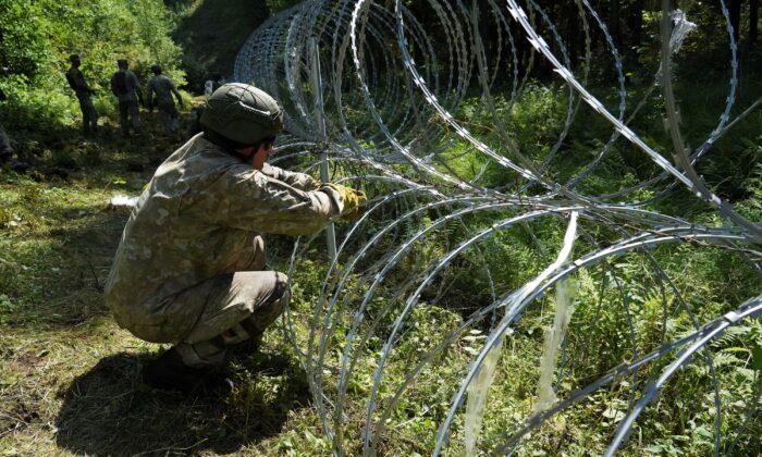 Lithuania Toughens Belarus Border With Razor Wire to Bar Migrants