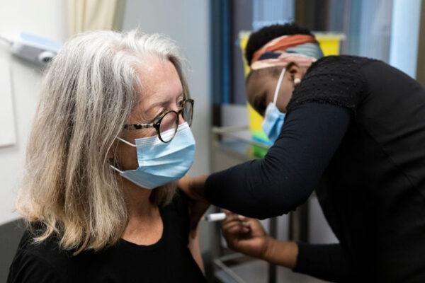 A nurse administers the AstraZeneca vaccine to a woman at the Sydney West COVID Vaccine Centre on May 7, 2021, in Sydney, Australia. (Brook Mitchell/Getty Images)
