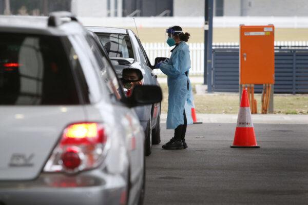 People arrive at a COVID-19 drive-through testing clinic in the suburb of Fairfield in Sydney, Australia on July 9, 2021. (Lisa Maree Williams/Getty Images)