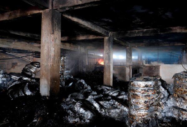 Burnt material lie inside a food and beverage factory in Rupganj, outside Dhaka, Bangladesh, on July 9, 2021. (Mahmud Hossain Opu/AP Photo)