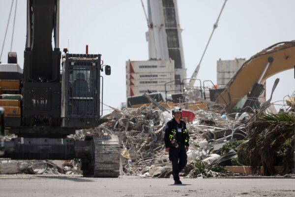 A rescue worker walks away from the remains of the collapsed 12-story Champlain Towers South condo building in Surfside, Fla., on July 08, 2021. (Anna Moneymaker/Getty Images)