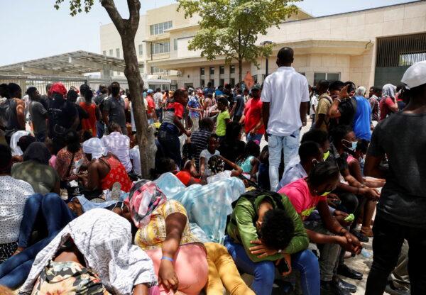 Haitians gather outside the U.S. Embassy after the assassination of President Jovenel Moïse, in Port-au-Prince, Haiti, on July 9, 2021. (Estailove St-Val/Reuters)