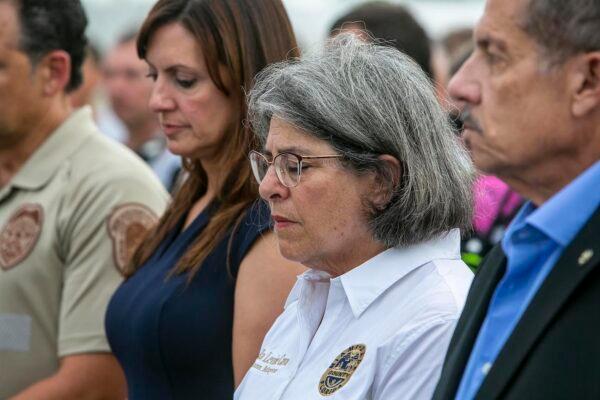 Miami-Dade County Mayor, Daniella Levine Cava, prays along with other officials in from of the rubble that once was Champlain Towers South in Surfside, Florida, on July 7, 2021. (Jose A Iglesias/Pool/Getty Images)