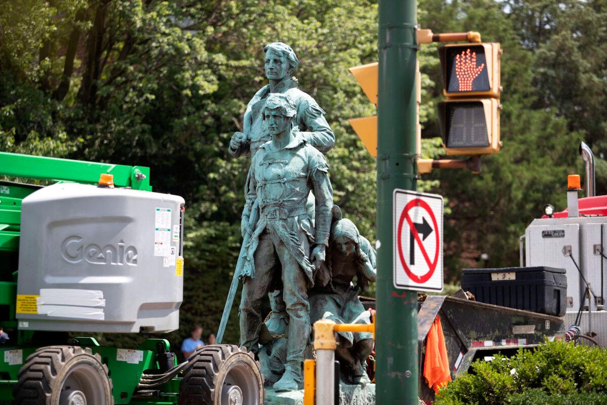 The statue of Meriwether Lewis, William Clark, and Sacagawea is removed from Charlottesville, Va., on July 10, 2021. (Ryan M. Kelly/AFP via Getty Images)