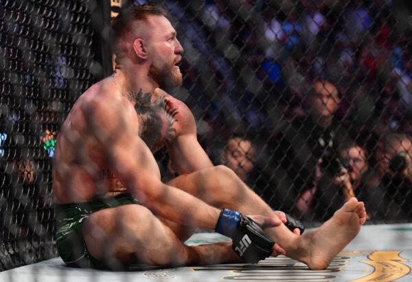 Conor McGregor holds his leg after suffering an injury against Dustin Poirier during UFC 264 at T-Mobile Arena. (Gary A. Vasquez-USA TODAY Sports)
