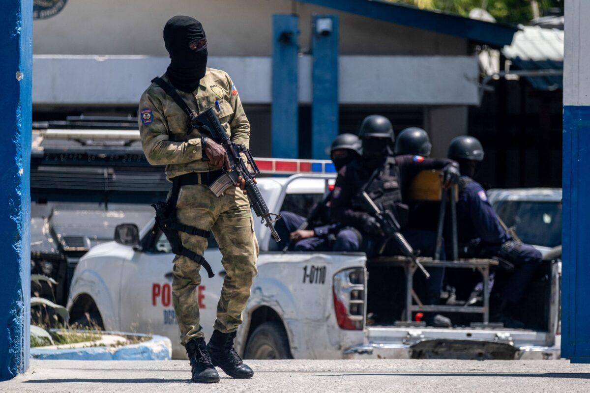 An armed Haitian Army troop guards the entrance of the General Directorate of the police where the suspects of the assassination of Haiti's President Jovenel Moise are detained, in Port-au-Prince, Haiti on July 10, 2021. (Ricardo Arduengo/Reuters)