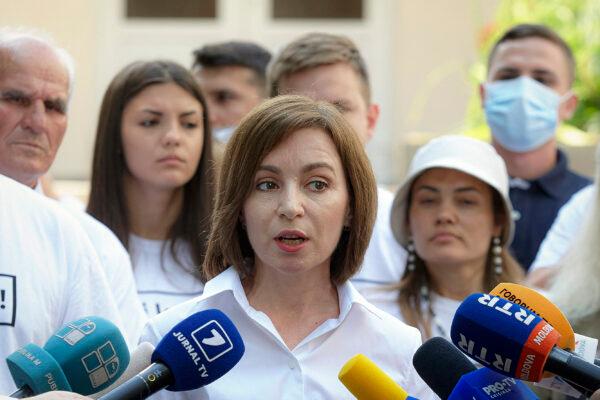 Moldovan President Maia Sandu speaks to the media after casting her vote in a snap parliamentary election, in Chisinau, Moldova, on July 11, 2021. (AP Photo/Aurel Obreja)