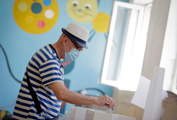 A man casts his vote at a polling station in Sofia, Bulgaria, on July 11, 2021. (Valentina Petrova/AP Photo)
