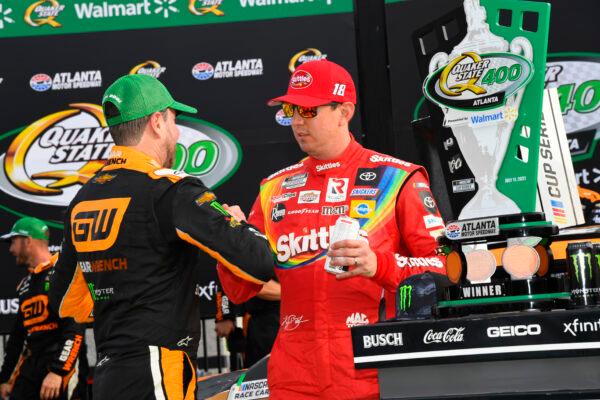 Kurt Busch is congratulated by his brother Kyle Busch after winning a NASCAR Cup Series auto race in Hampton, Ga., on July, 11, 2021. (John Amis/AP Photo)