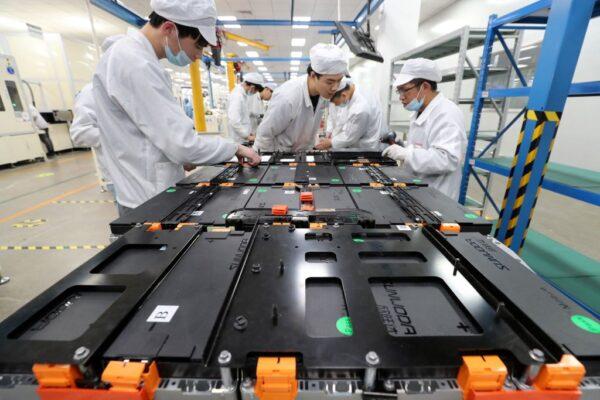 This photo, taken on March 12, 2021, shows workers at a factory for Xinwangda Electric Vehicle Battery Co., which makes lithium batteries for electric cars and other uses in Nanjing, Jiangsu province, China. (STR/AFP via Getty Images)