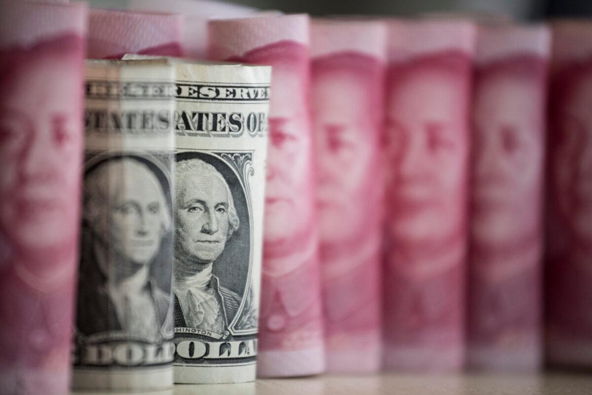 Chinese 100 yuan notes and U.S. $1 notes in Beijing on Jan. 6, 2017. (Fred Dufour/AFP via Getty Images)