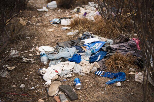A file photo shows litter covering the ground at a migrant oasis that offers water and candles just off the road in Bisbee, Arizona, near the US/Mexico border. (JIM WATSON/AFP via Getty Images)