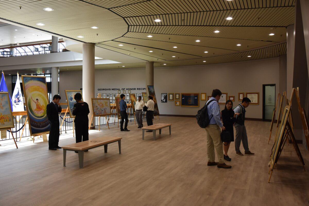 Visitors view paintings from The Art of Zhen Shan Ren International Exhibition at the James<span style="font-weight: 400;"> H. "Sloppy" Floyd Building </span>on July 8, 2021. (The Epoch Times)