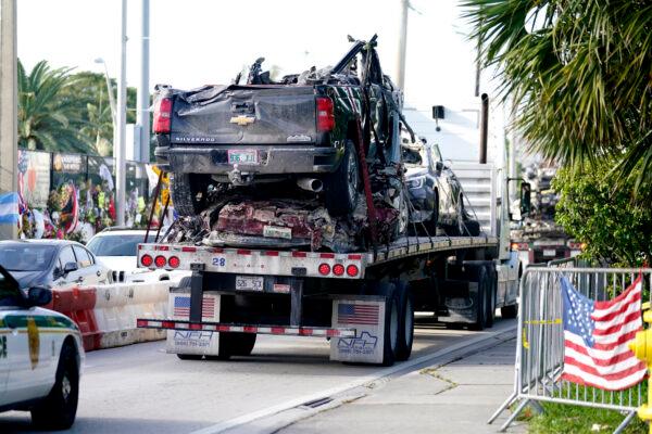 Damaged vehicles are transported from the rubble of the Champlain Towers South building, as removal and recovery work continues at the site of the partially collapsed condo building, in Surfside, Fla., on July 13, 2021. (Lynne Sladky/AP Photo)