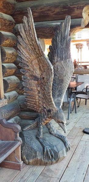 Camp 18, located in Elsie, on the way to the coast, boasts large wooden sculptures like this brilliantly carved eagle. (Anita L. Sherman)