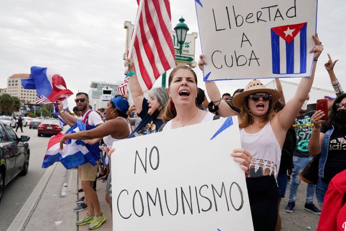 Cuban exiles rally at Versailles Restaurant in Miami's Little Havana neighborhood in support of protesters in Cuba, July 12, 2021, in Miami. Sunday's protests in Cuba marked some of the biggest displays of antigovernment sentiment in the tightly controlled country in years. (AP Photo/Marta Lavandier)
