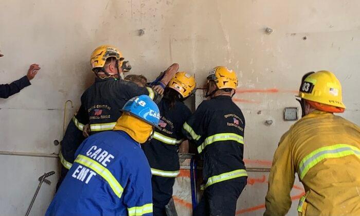 Firefighters Rescue Woman Wedged Between Two Concrete Walls