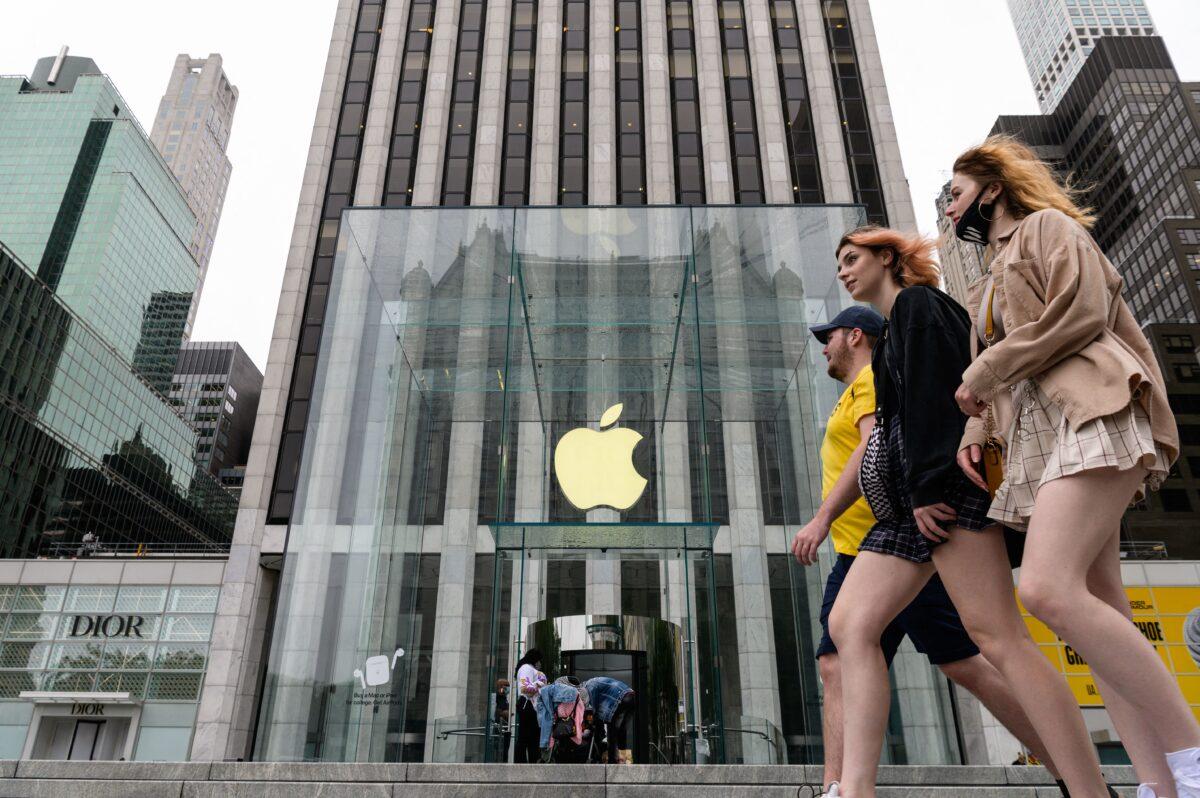 People walk past an Apple retail store in New York on July 13, 2021. (Angela Weiss/AFP via Getty Images)