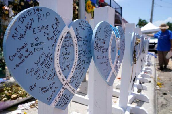 A wooden heart at a makeshift memorial remembers the family of Vishal and Bhavna Patel, who died along with their 1-year-old daughter Aishani, in the collapse of the nearby Champlain Towers South building, in Surfside, Fla., on July 14, 2021. (Lynne Sladky/AP Photo)