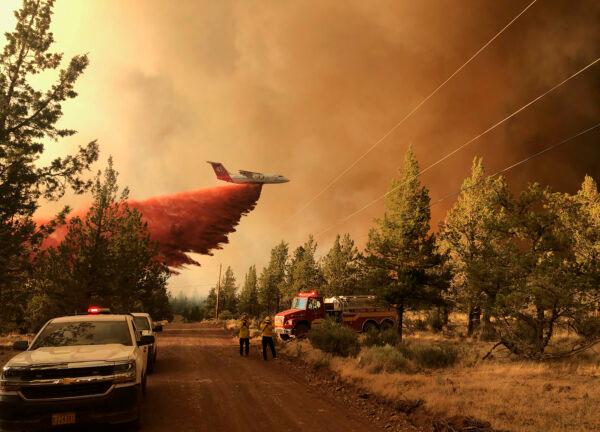 A firefighting tanker makes a retardant drop over the Grandview Fire near Sisters, Ore., on July 11, 2021. (Oregon Department of Forestry via AP)