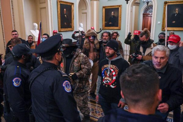 Douglas Jensen (C) speaks to U.S. Capitol Police officers inside the building in Washington on Jan. 6, 2021. (Saul Loeb/AFP via Getty Images)